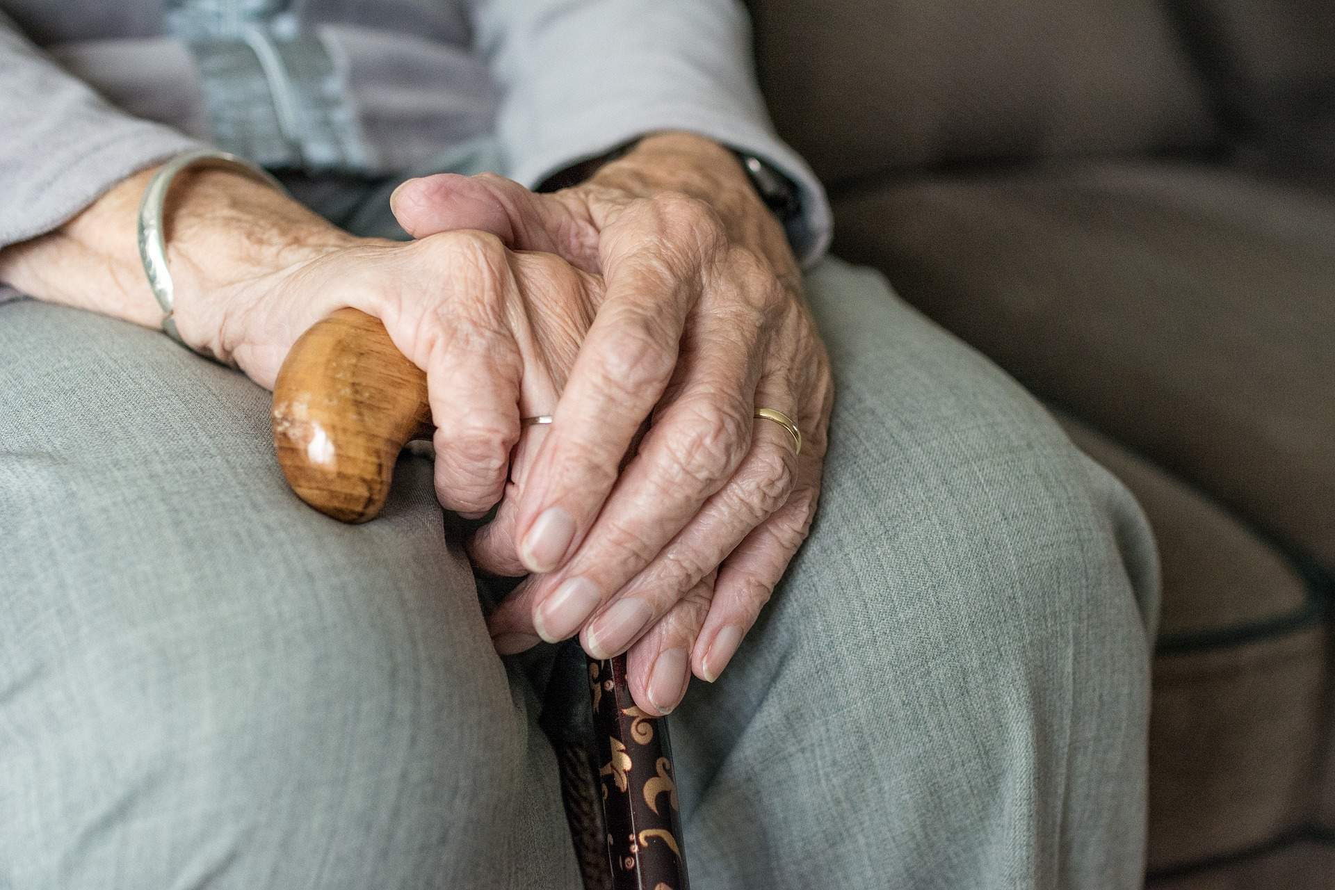 Caregiver holding senior hand
